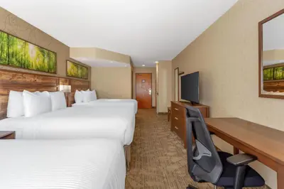 a hotel room with two beds and a desk at Best Western Plus Valemount Inn & Suites in Valemount