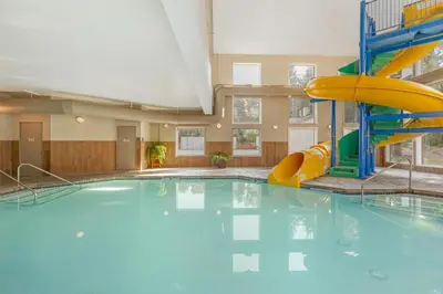 a swimming pool with a slide in a building at Best Western Plus Valemount Inn & Suites in Valemount