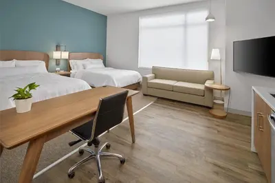 a hotel room with a desk and a bed and a couch at Element Edmonton West in Edmonton