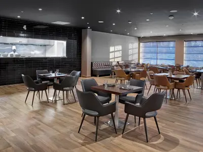 a restaurant with tables and chairs in a room at Element Edmonton West in Edmonton