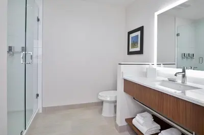 a bathroom with a sink and a toilet and a shower at Four Points by Sheraton Edmonton West in Edmonton