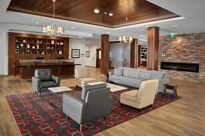 a lobby with a couch and chairs and a fireplace at Four Points by Sheraton Edmonton West in Edmonton