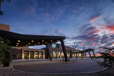 a lit up building with a cloudy sky in the background at The Westin Calgary Airport in Calgary