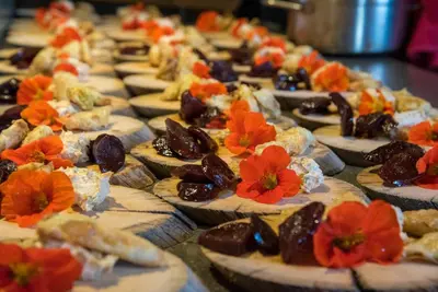 a row of appetizers with red flowers on them at Inn on the Lake - Whitehorse in Marsh Lake