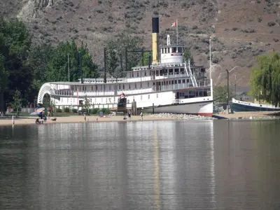 a large boat is docked in the water at Okanagan Lakefront Resort in Penticton