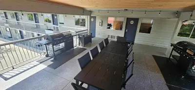 a balcony with a table and benches on a building at Okanagan Lakefront Resort in Penticton