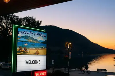 a sign on the side of a building next to a lake at Okanagan Lakefront Resort in Penticton