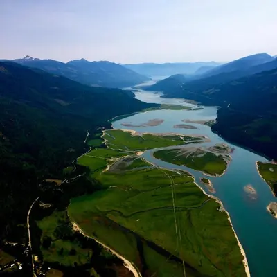 an aerial view of a river with mountains at Alpenrose Revelstoke Bed & Breakfast in Revelstoke