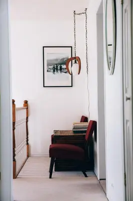 a hallway with a chair and a picture on the wall at Alpenrose Revelstoke Bed & Breakfast in Revelstoke