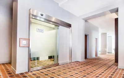 an empty hallway with a glass door in a building at Matrix Hotel in Edmonton