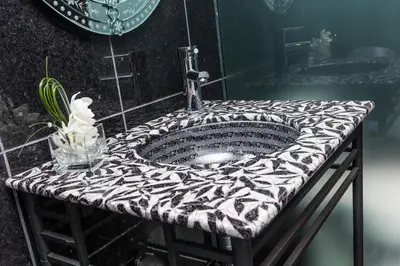 a bathroom sink with a black and white counter top at Matrix Hotel in Edmonton