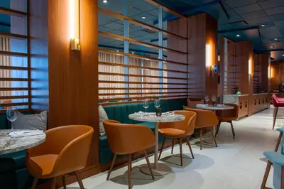a restaurant with tables and chairs and windows at Matrix Hotel in Edmonton