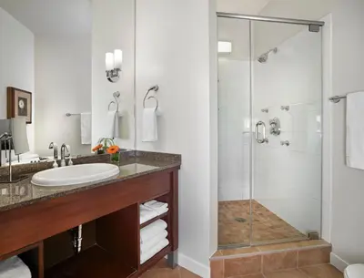 a bathroom with a sink and a shower at Metterra Hotel on Whyte in Edmonton