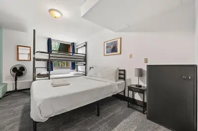 a bedroom with a bed and a bunk bed at HI Lake Louise Alpine Centre - Hostel in Lake Louise