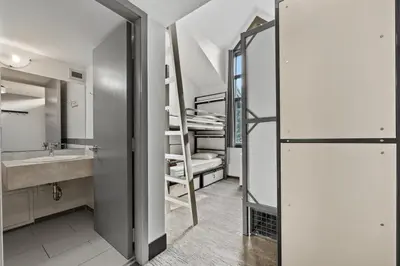 a bathroom with a sink and a bathroom with bunk beds at HI Lake Louise Alpine Centre - Hostel in Lake Louise