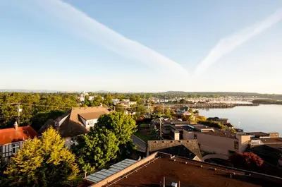 a view of a city with a river and buildings at Oak Bay Beach Hotel in Victoria
