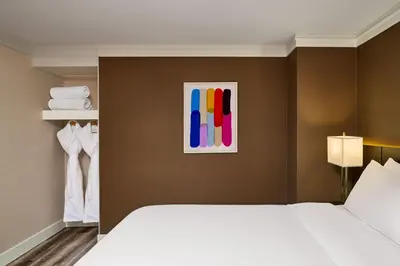a bedroom with a bed and a painting on the wall at Varscona Hotel on Whyte in Edmonton