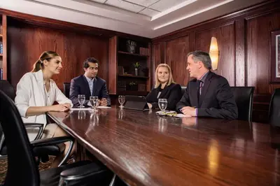 a group of people sitting around a table at Varscona Hotel on Whyte in Edmonton