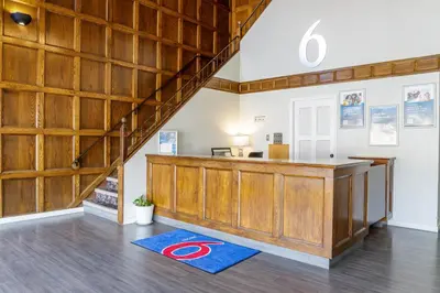 a large room with a counter and a staircase at Motel 6 Merritt, BC in Merritt