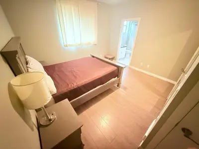 a small bedroom with a bed and a window at Super 8 by Wyndham Salmon Arm in Salmon Arm