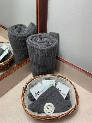 a basket of towels sitting on the floor in front of a mirror at Monashee Lodge in Revelstoke