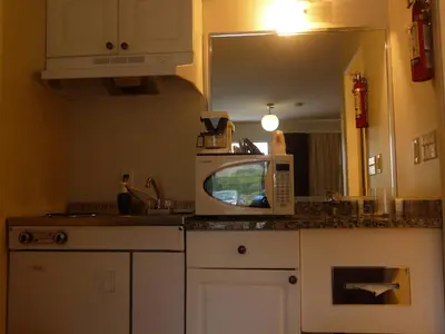 a kitchen with a microwave on top of a counter at Super 8 by Wyndham Kamloops East in Kamloops