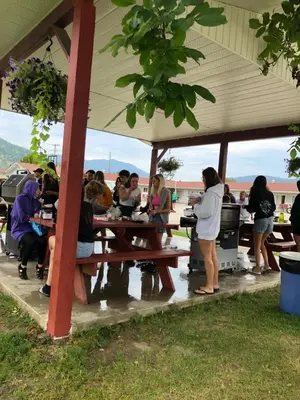 a group of people sitting at a picnic table at Paradise Motel in Sicamous