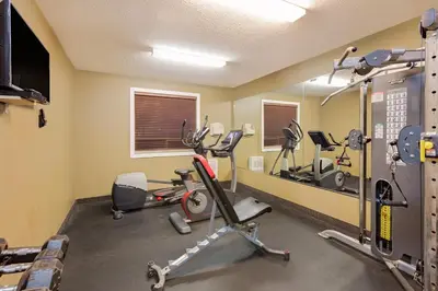 a gym with several exercise bikes and a mirror at Ramada by Wyndham Cold Lake in Cold Lake