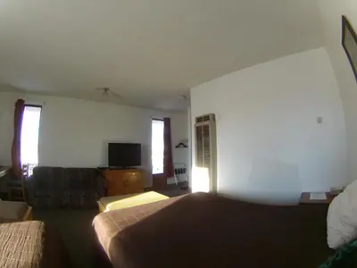 a hotel room with a bed and a couch at Rycroft Hotel in Rycroft