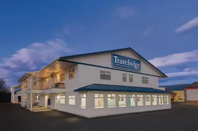 a large white building with a sign on it at Travelodge by Wyndham Salmon Arm BC in Salmon Arm