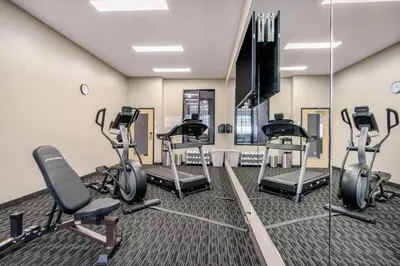 a gym with several exercise bikes and a mirror at Comfort Inn & Suites in North Battleford