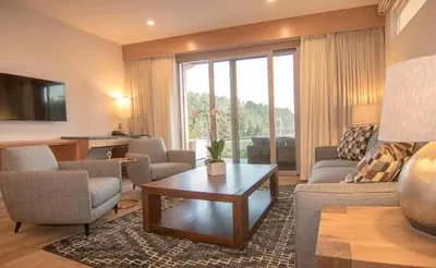 a living room with a couch and a table at Harbour House Hotel in Ganges