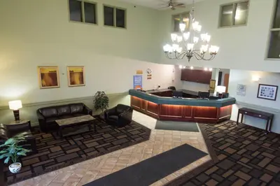 a lobby with a couch and a waiting room at Nova Inn Acheson in Spruce Grove