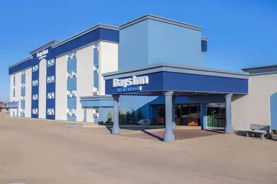 a building with a sign on the front of it at Days Inn & Conference Centre by Wyndham Camrose Norsemen in Camrose