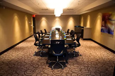 a conference room with a long table and chairs at Holiday Inn Hotel & Suites Red Deer by IHG in Red Deer