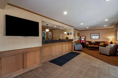 a hotel lobby with a flat screen tv on a wall at SureStay Plus Hotel by Best Western Salmon Arm in Salmon Arm