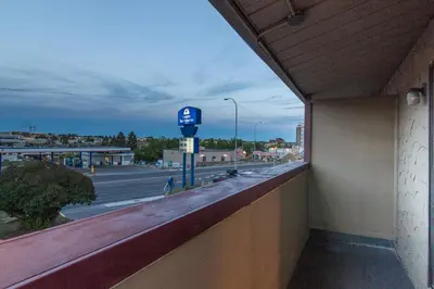 a view from the balcony of a building with a parking meter at Canadas Best Value Inn Chinook Station in Calgary