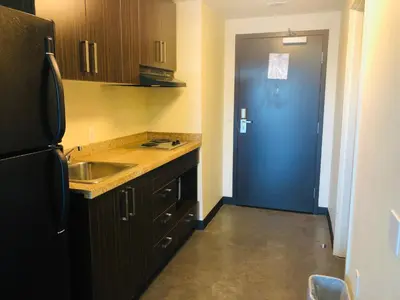 a kitchen with a sink and a blue door at SAIT Residence & Conference Centre - Calgary in Calgary