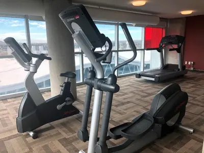 a gym with two tread machines in a building at SAIT Residence & Conference Centre - Calgary in Calgary