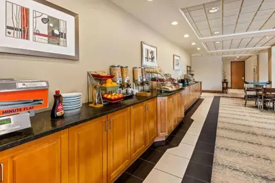 a cafeteria with a buffet line with food at Wingate by Wyndham Calgary South in Calgary