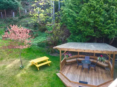 an overhead view of a garden with a gazebo and a picnic table at Casa Grande Inn in Qualicum Beach