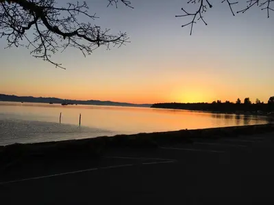 a sunset over a body of water at Casa Grande Inn in Qualicum Beach