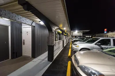 a row of cars parked next to a building at night at Olympia Lodge in Calgary