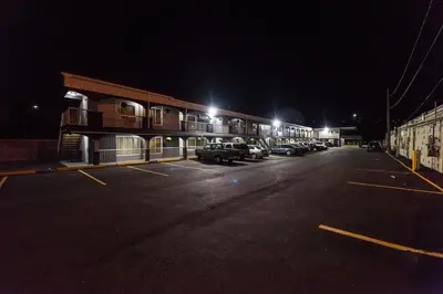 a parking lot with cars parked in front of a building at Olympia Lodge in Calgary