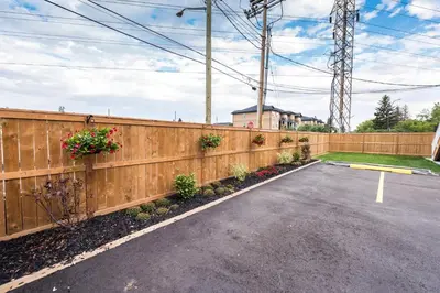 a fence with flowers on the side of a road at Olympia Lodge in Calgary
