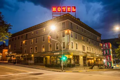 a hotel on the corner of a street at night at Hume Hotel & Spa in Nelson