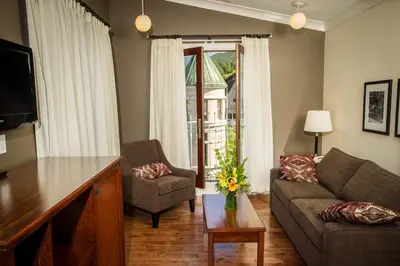 a living room with a couch and a table at Hume Hotel & Spa in Nelson