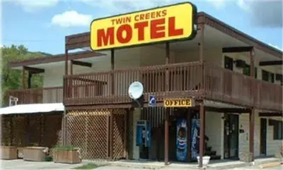 a motel with a sign on the front of it at Twin Creeks Motel in Lumby