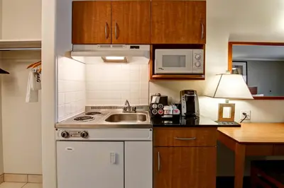 a kitchen with a sink and a stove top oven at Canalta Jurassic - Drumheller in Drumheller