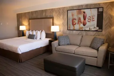 a hotel room with a bed and a couch at Canalta Airdrie in Airdrie